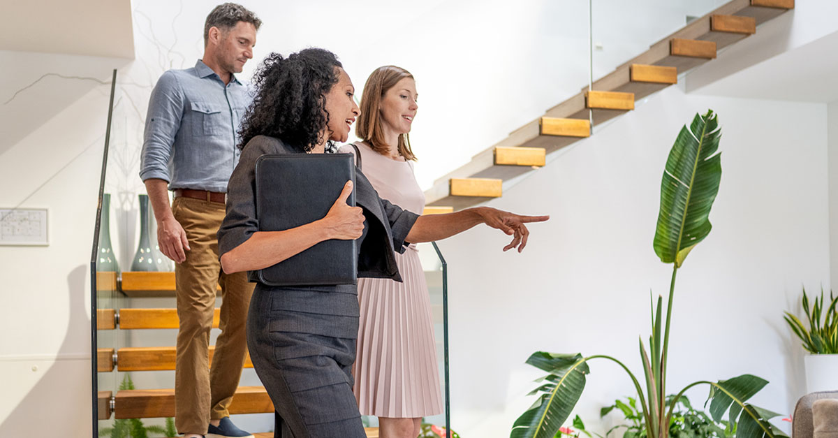 An agent showing a home with an indoor garden to her clients